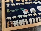 a picture of a display of animal figurines in a wooden frame