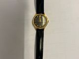 a close up of a wrist watch on a white surface