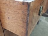 a close up of a wooden drawer with a marble top