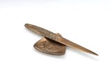 a knife and a spoon sitting on top of a piece of metal