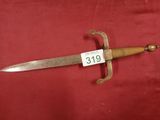 a close up of a sword on a red surface
