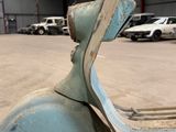 a blue scooter that is parked in a parking lot