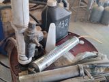 a red barrel with a bunch of pipes on it in a garage
