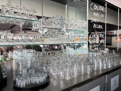 many glasses on the counter in the restaurant