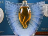 un flacon de parfum sur lequel figure l'image d'une femme, à côté d'une boîte