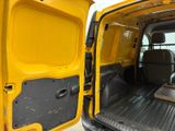 a yellow van with the door open and a bench in the back
