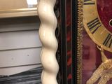 a clock that is sitting on a table next to a lamp