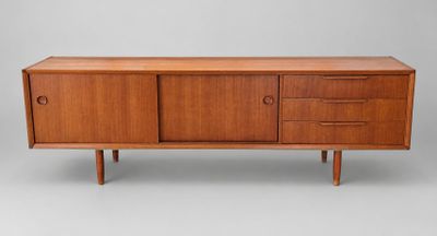 a mid century teak sideboard with three drawers and two doors