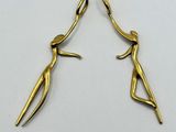a pair of gold plated earrings with a stylized design
