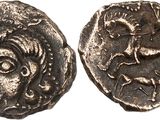 a silver coin with an image of a man and a horse