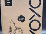 the box of a stroller with a handle is open on a table