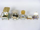 four small boxes with rings and a ring box on top of them