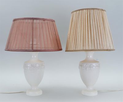 pair of white lamps with pink shades on a white background