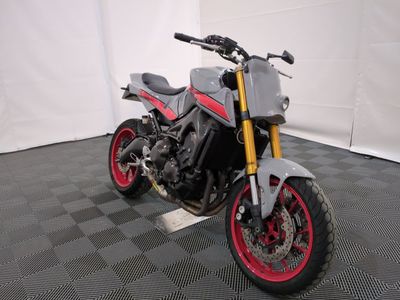 a picture of a motorcycle parked on a black and white checkered floor