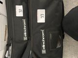two bags and a ball on the floor next to each other