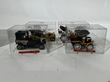 two toy cars in a clear box on a table