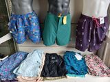 several men ' s underwear are displayed on a shelf in a store