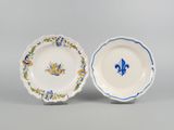 two plates with blue and yellow designs on them on a gray surface
