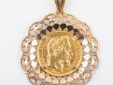 an image of a gold coin pendant with a woman ' s face on it