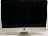 a computer monitor sitting on top of a white table