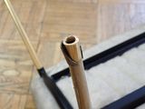 a wooden stick sticking out of a piece of luggage on the floor
