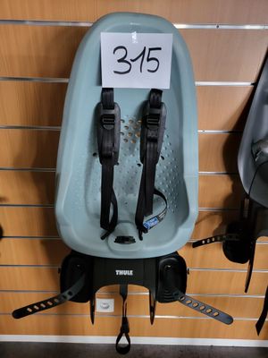 two baby strollers hanging on the wall with a price tag