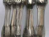 a lot of silver spoons and spoons on the table