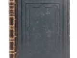 an old book sitting on top of a table next to a book