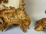 deux vases décorés, dorés et blancs, posés sur une table