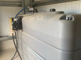 a tank with a hose attached to it in a garage