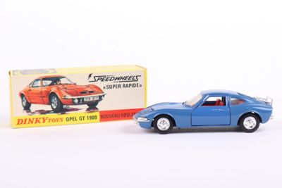 a blue toy car next to a box on a white surface