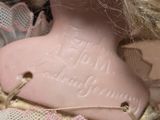 a doll that has a pink heart on it ' s head