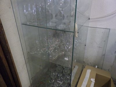 a glass case with wine glasses in it