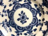 a blue and white plate with a flower design on it