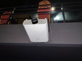 a white toaster sitting on the ledge of a building