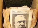 a box full of old books with a picture of a man in it