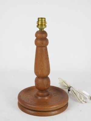 a wooden table lamp that has a cord attached to it