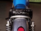 a close up of a blue motorcycle with a tag on it
