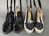 four pairs of black and white shoes hanging from a rack
