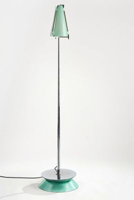 a green floor lamp with a metal base and a green shade