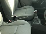 a picture of a car that has a cup holder in the front seat