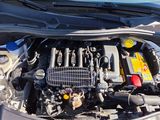 a blue car with its hood open and the engine in it