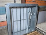 an image of a metal enclosure in a warehouse