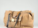 tan leather tote bag with black leather handles