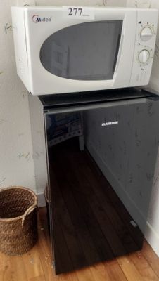 a microwave that is sitting on top of a refrigerator
