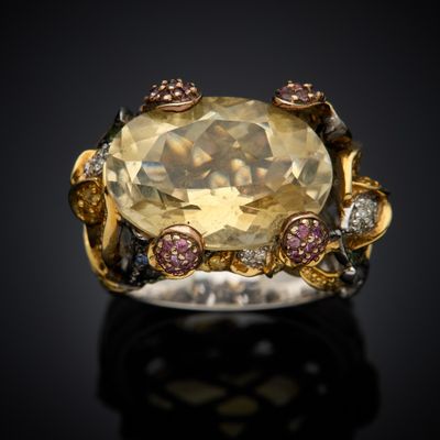 an image of a ring with a large yellow topazr surrounded by pink and white diamonds