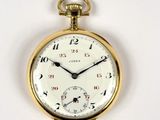 a close up of a pocket watch on a white surface