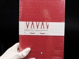 a person holding a red book in their hand