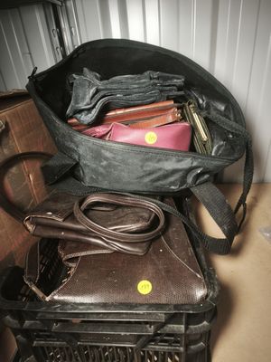 a black bag with a laptop in it sitting on top of a suitcase