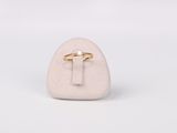 a white stone with a gold ring on top of it